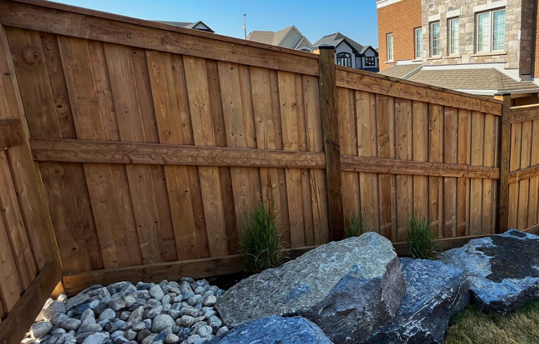 Custom wood fencing style built in a backyard called the Board on Batten wood fence.